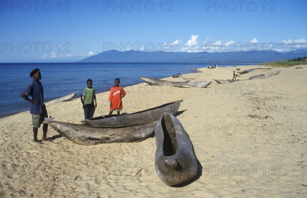 Local man and boy with canoes near Kande Beach on Lake Malawi, Malawi, Africa, July 2000, vintage, retro, old, historic
