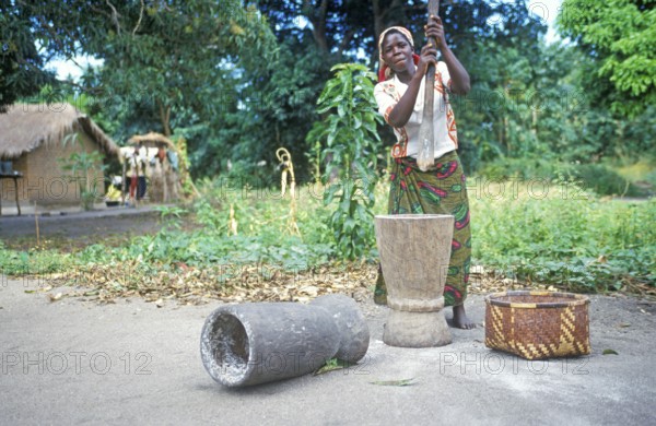Woman stomping cassava in a village near Kande on Lake Malawi, Malawi, Africa, July 2000, vintage, retro, old, historic