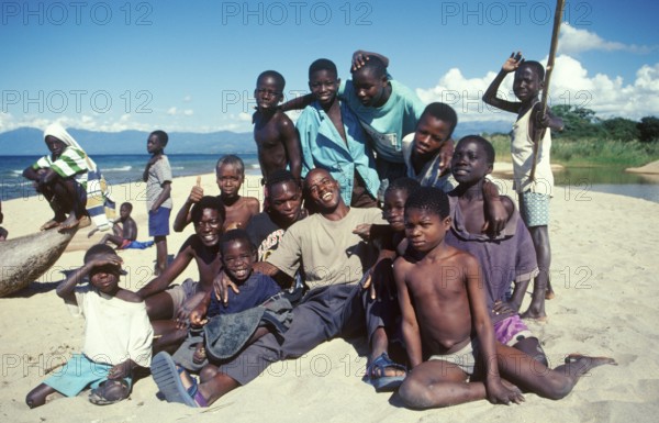 Boys and young men pose for a photo on Kande Beach on Lake Malawi, Malawi, Africa, July 2000, vintage, retro, old, historic