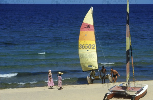 Local woman and tourist with catamaran on Lake Malawi, Kande, Malawi, Africa, July 2000, vintage, retro, old, historic