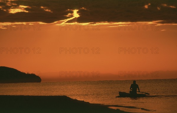 Sunrise over Lake Malawi near Kande, man in dugout, Kande, Malawi, Africa, July 2000, vintage, retro, old, historic
