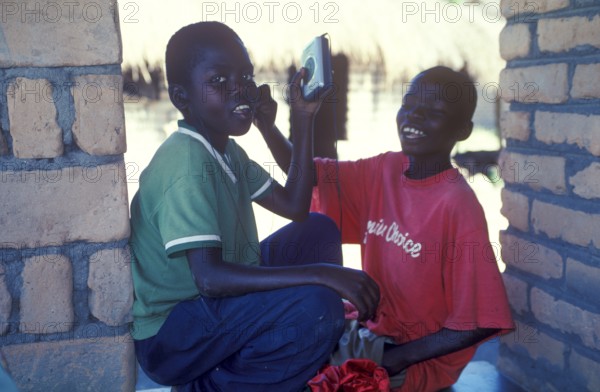 Two local boys with Walkman in a village near Kande, Lake Malawi, Malawi, Africa, July 2000, vintage, retro, old, historic