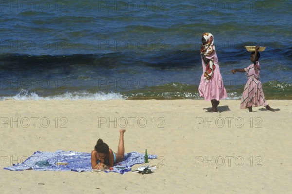 Tourist in bikini and traditionally dressed local woman at Kande Beach on Lake Malawi, Malawi, Africa, July 2000, vintage, retro, old, historic