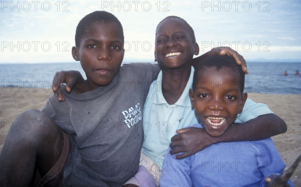 Three boys posing for camera, Chitimba, Lake Malawi, Africa, July 2000, vintage, retro, old, historic