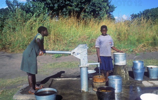 Two young woman at a well in a village near Kande on Lake Malawi, Malawi, Africa, July 2000, vintage, retro, old, historic