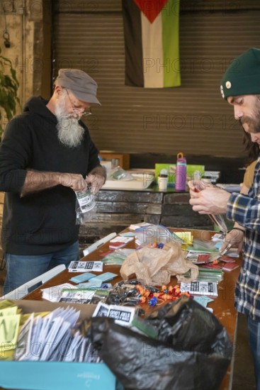 Detroit, Michigan - Volunteers with the Detroit Peoples Assembly put together whistle kits. The whistles are designed to alert others in the community when immigration agents are nearby