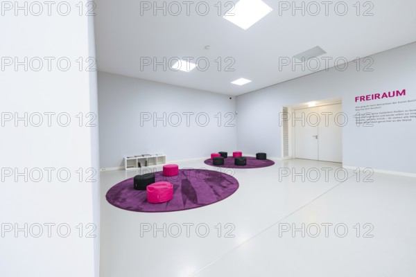 Modern room with purple and black seating and lettering on the wall, Open Horizons exhibition, Schauwerk Sindelfingen, Böblingen district, Germany