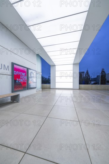 Modern museum entrance with blue lighting and large windows in the evening, Open Horizons exhibition, Schauwerk Sindelfingen, Böblingen district, Germany
