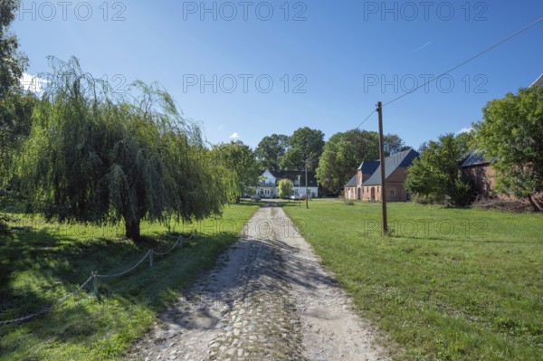 Old road to the old manor house, on the right the former horse stable from 1923, Gut Othenstorf, Mecklenburg-Western Pomerania, Germany