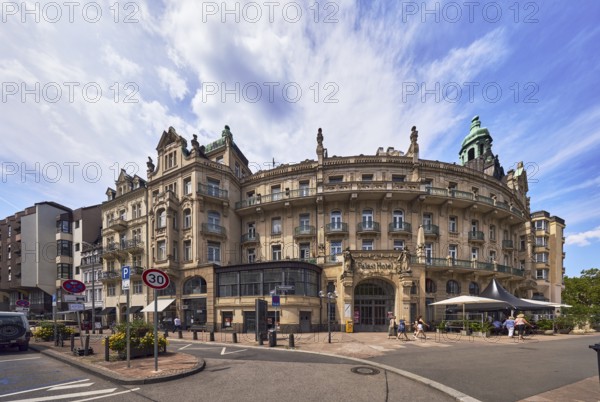 Historic building, former hotel palace hotel, barrier bollard, street, round faÃ§ade with windows, catering, outdoor area, restaurant, parking strips with vehicles, pedestrians as accessories, blue sky, cirrostratus clouds, cumulus clouds, wreath ground, Wiesbaden, state capital, district-free city, Hesse, Germany