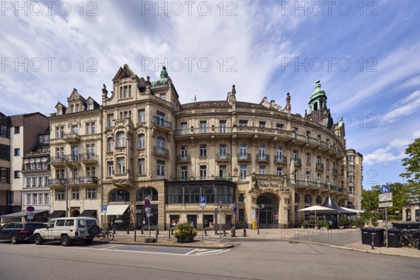 Historic building, former hotel palace hotel, barrier bollard, street, round faÃ§ade with windows, catering, outdoor area, restaurant, parking strip with vehicles, blue sky, cirrostratus clouds, cirrus clouds, cumulus clouds, wreath square, Wiesbaden, state capital, district-free city, Hesse, Germany