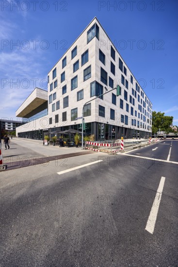 Pedestrian zone, road, lanes, road markings directional arrow, traffic light, commercial building, modern architecture, faÃ§ade with windows, fenced construction site, barrier, road construction, gastronomy Waffel House, trees, deep blue sky, cirrus clouds, intersection Schwalbacher StraÃŸe with German Unity Square, Wiesbaden, state capital, district-free city, Hesse, Germany