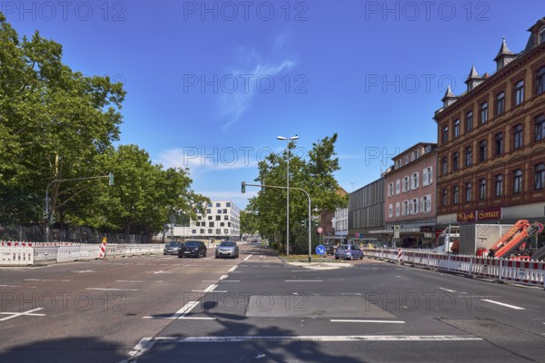 Traffic light intersection, central island, fenced construction site, barrier, road construction, general architecture, modern building, residential and commercial buildings, trees, cars, vehicles, blue sky, cirrus clouds, intersection Dotzheimer StraÃŸe, LuisenstraÃŸe and Schwalbacher StraÃŸe, Wiesbaden, state capital, district-free city, Hesse, Germany