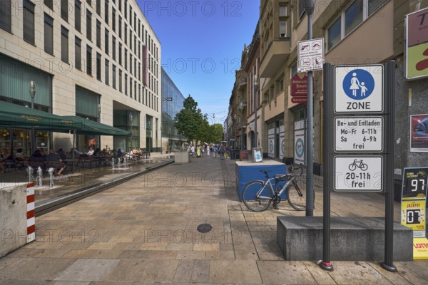 LuisenForum, shopping center, pedestrian zone, fountain, shops, shopping, general architecture, modern architecture, residential buildings and commercial buildings, outdoor area of a restaurant, traffic sign pedestrian zone, additional sign for loading and unloading free, additional sign bicycles free, firearms zone, blue sky, cloudless, Kirchgasse, Wiesbaden, state capital, district-free city, Hesse, Germany