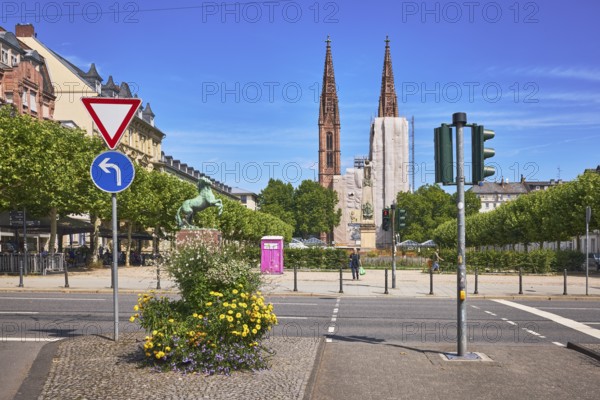 Traffic island, St. Boniface Catholic Church, barrier bollard, pedestrian crossing, traffic lights, traffic signs, right of way, prescribed direction of travel left, flower pots, general architecture, houses, scaffolding, renovation, trees, blue sky, cirrus clouds, RheinstraÃŸe, Luisenplatz, Wiesbaden, state capital, district-free city, Hesse, Germany