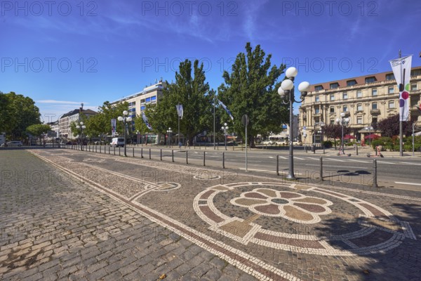 Sidewalk, paving stones, mosaic, pattern, barrier bollard, lantern, general architecture, trees, flag on flagpole, blue sky, cirrus clouds, WilhelmstraÃŸe street, Wiesbaden, state capital, district-free city, Hesse, Germany