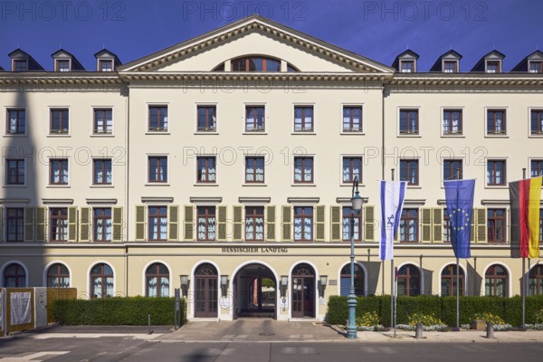 Hessian state parliament, former court marshal's office, architectural style classicism, flagpoles, flags, Israeli flag, German flag, European flag, entrance area, faÃ§ade with windows and shutters, dormers, entrance door, sign state parliament, blue sky, cirrus clouds, castle square, Wiesbaden, state capital, district-free city, Hesse, Germany
