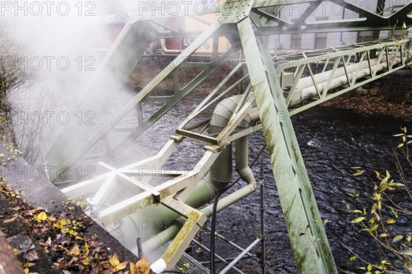 District heating pipeline over the Wupper river, steam escapes, Wuppertal, Germany