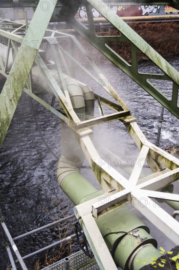 District heating pipeline over the Wupper river, steam escapes, Wuppertal, Germany