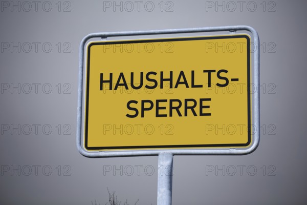 (Photo montage) Close-up of a town entrance sign with the inscription HOUSEHOLD LOCK