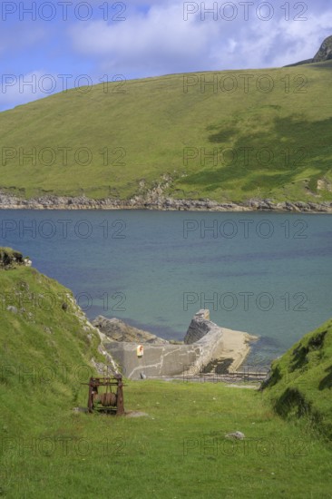 Rusted winch above small harbour, Portacloy loop cliff walk, Muingnabo, County Mayo, Ireland