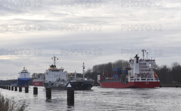 Ships, container ships, cargo ships, tankers meet in front of sunset in the Kiel Canal, NOK, Kiel Canal, Kiel Canal, Schleswig-Holstein, Germany