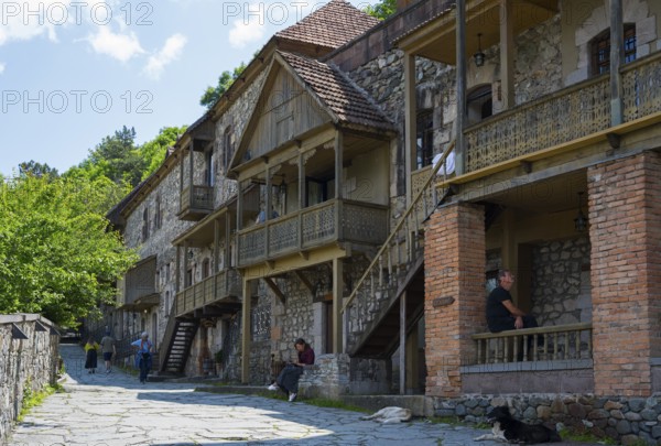 A narrow street with rustic stone houses, people, and relaxed atmosphere, Old Town, Sharambeyan Street, Dilijan, Delijan, Delijan, Tavush Province, Armenia