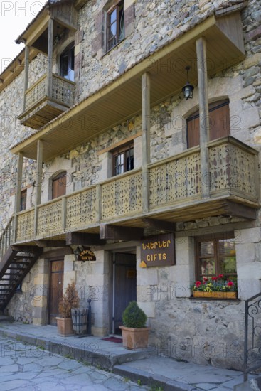 Rustic stone house with wooden balconies and flower box in traditional design, Old Town, Sharambeyan Street, Dilijan, Delijan, Delijan, Tavush Province, Armenia