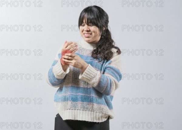 Asian woman with arthritis and hand pain isolated. Unhappy asian girl suffering with pain hands