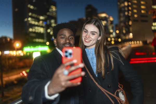 Diverse friends posing for a self portrait with a smartphone, smiling warmly as they enjoy a casual evening outing in the vibrant, illuminated urban cityscape
