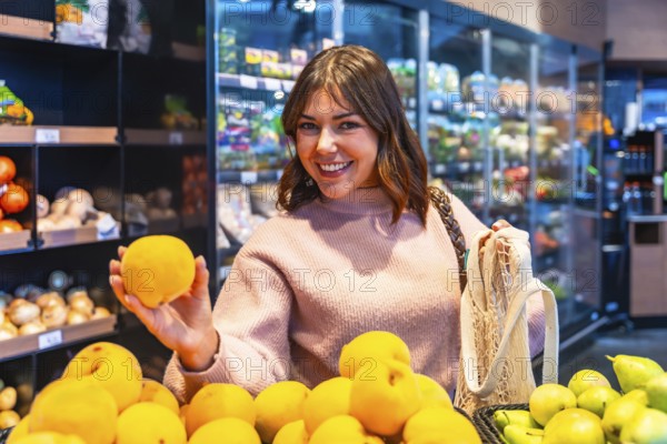 Young woman shopping for organic produce in a grocery store, holding a fresh yellow fruit and smiling, promoting healthy eating habits and sustainable choices