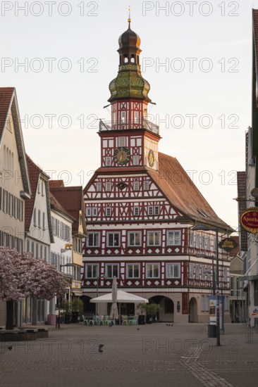 Kirchheim unter Teck, Baden-WÃ¼rttemberg, MarktstraÃŸe with historic half-timbered town hall at sunrise in spring and cherry blossom