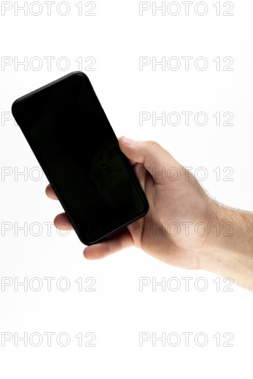 Hand holding a black smartphone against a white background
