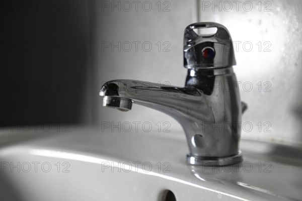 Modern chrome plated faucet in a bathroom