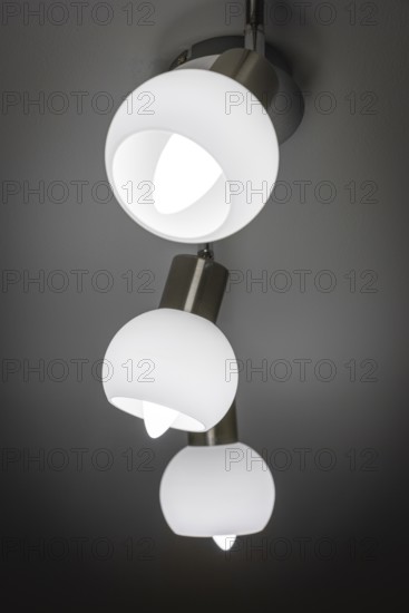 Modern ceiling lamp with three white, bowl-shaped lights