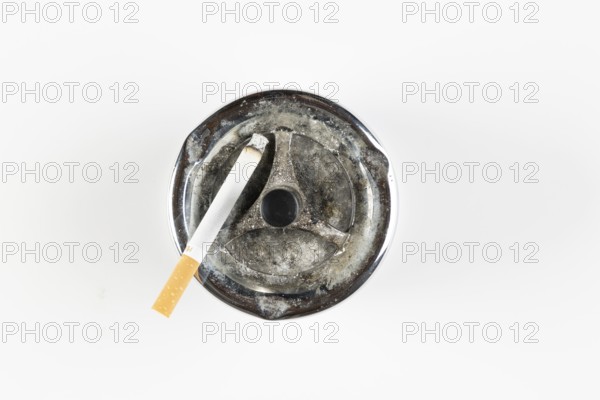 Used ashtray with cigarette, on white background