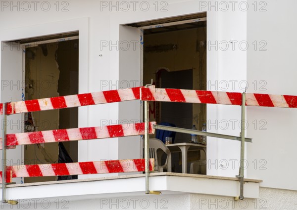 Balcony secured with red and white striped slats at the construction site of a house, Nazare, Portugal