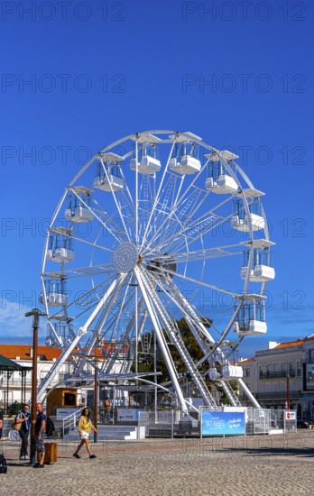 Ferris wheel next to the holy church Santuario de Nossa in Nazare, Portugal