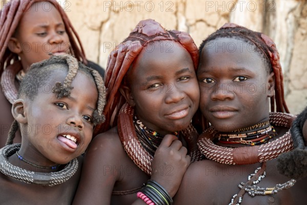 Group of Himba people, Himba woman, traditional Himba village, Kaokoveld, Kunene, Namibia