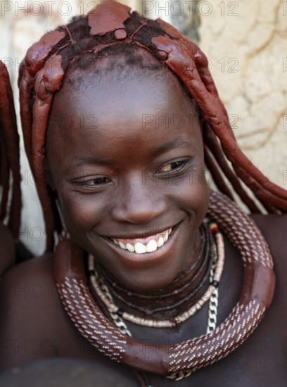 Himba woman laughing, traditional Himba village, Kaokoveld, Kunene, Namibia
