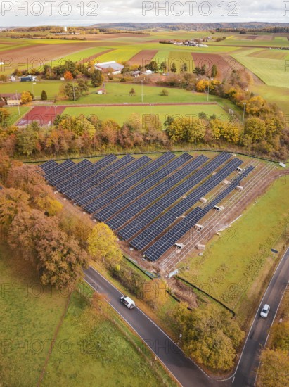 Solar systems in the middle of an autumnal landscape with a rural road, construction PV Freifaechenanlage, Weil der Stadt, Germany