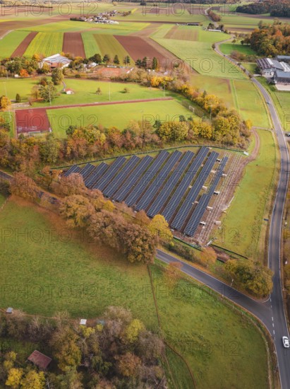 View of solar panels in rural area with roads and autumn trees, PV Freifaechenanlage construction, Weil der Stadt, Germany
