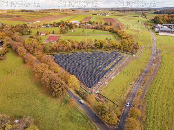 Panoramic view of solar panels surrounded by landscape characterized by autumn leaves, PV Freifaechenanlage building, Weil der Stadt, Germany