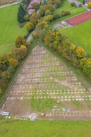 Parceled green area in triangle shape, surrounded by trees and infrastructural facilities, PV FreifÃ¤chenanlage construction, Weil der Stadt, Germany
