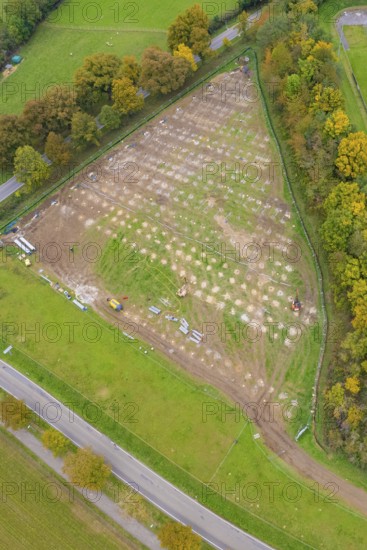 Aerial view of a field with sections under construction, surrounded by roads and trees, PV Freifaechenanlage construction, Weil der Stadt, Germany