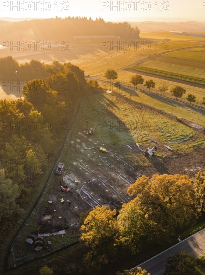 Natural landscape in morning light with construction and dense forest areas, PV open-air plant construction, Weil der Stadt, Germany