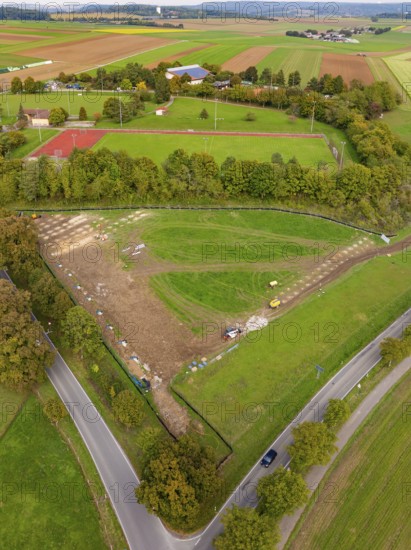Landscape with fields, trees and a sports field photographed from a bird's eye view, PV Freifaechenanlage construction, Weil der Stadt, Germany