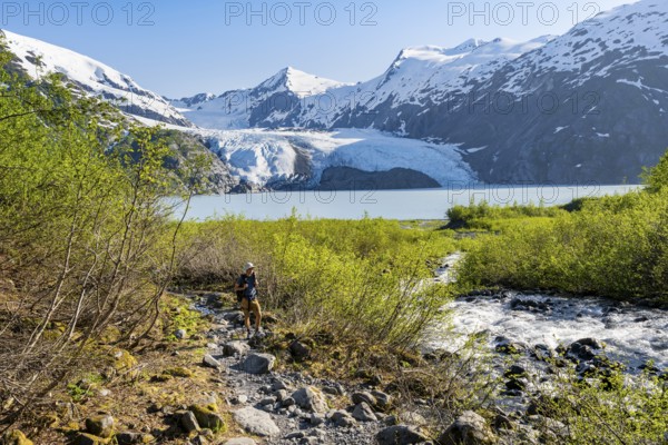 Hikers on the Portage Pass Trail, snowy mountains, Portage Glacier and Portage Lake, near Whittier, Alaska, USA
