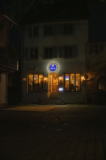 Inviting evening restaurant with illuminated windows and a sign, Sindelfingen, Böblingen district, Germany