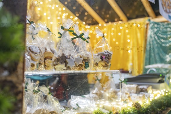 Packaged pastries on a Christmas market stand under twinkling lights, Christmas market 2025, Nagold, Black Forest, Calw district, Germany